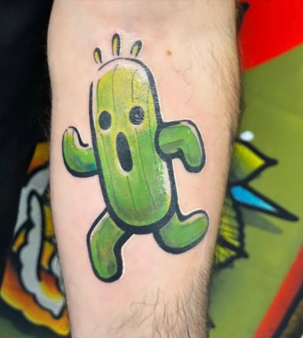Bright green cactuar video game character color tattoo on the forearm