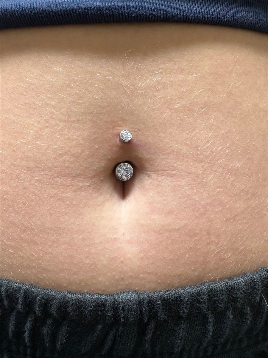 Fresh navel piercing with double jeweled barbell