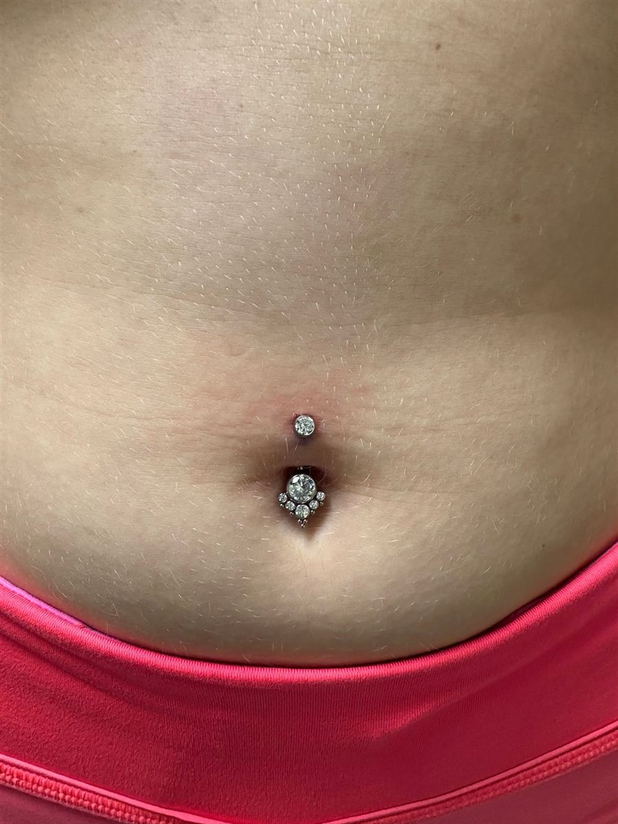 Navel piercing with jeweled implant-grade jewelry, pierced in Glen Rose TX