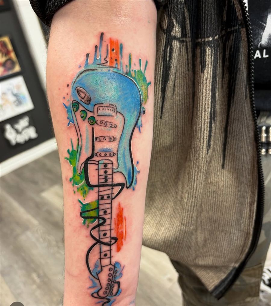 Watercolor electric guitar color tattoo on the forearm